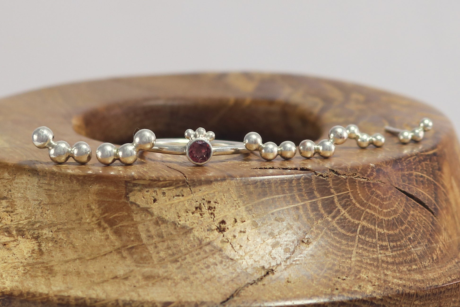 Sterling silver studs with three bubbles along a curve.