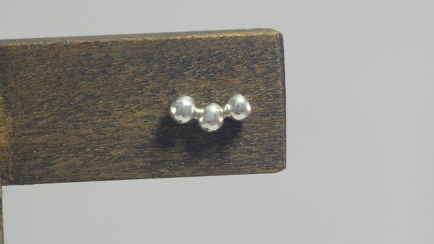 Sterling silver studs with three bubbles along a curve.