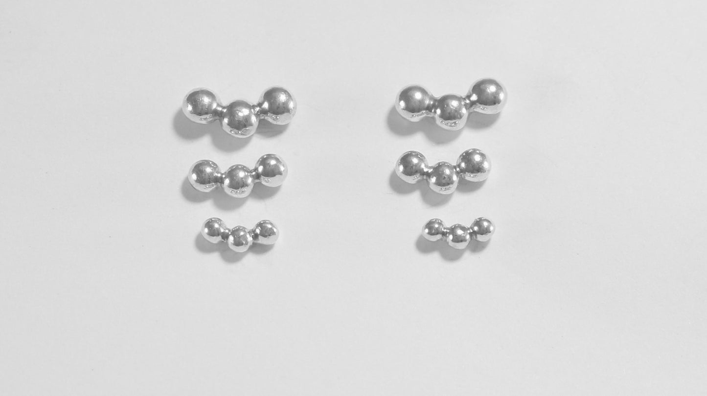 Sterling silver studs with three bubbles along a curve.