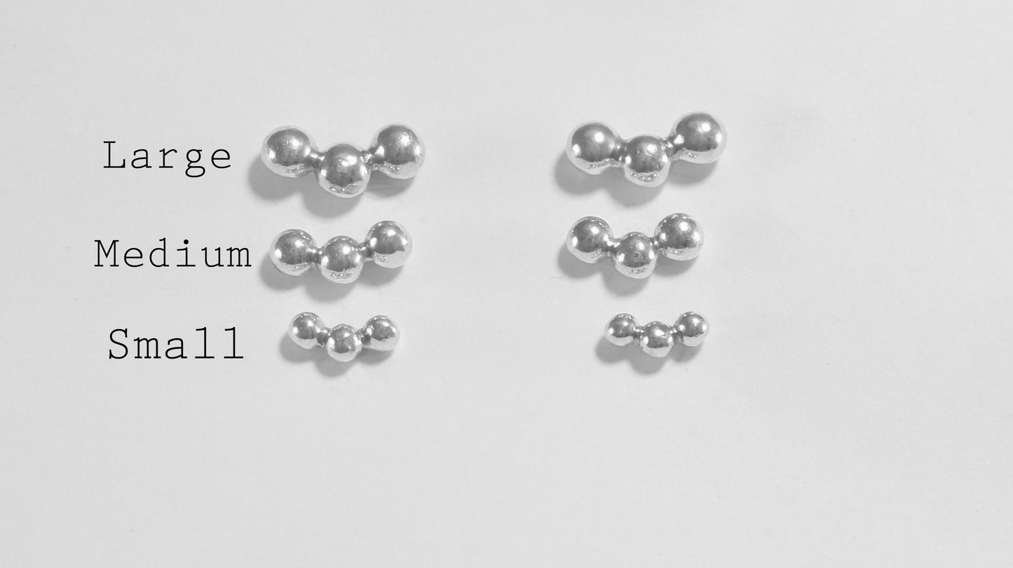 Sterling silver studs with three bubbles along a curve.