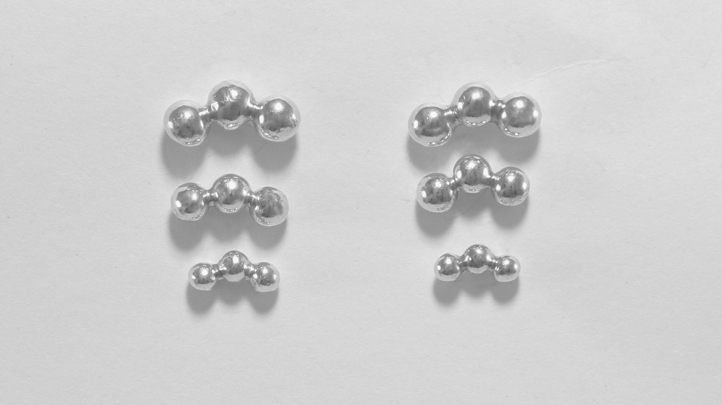Sterling silver studs with three bubbles along a curve.