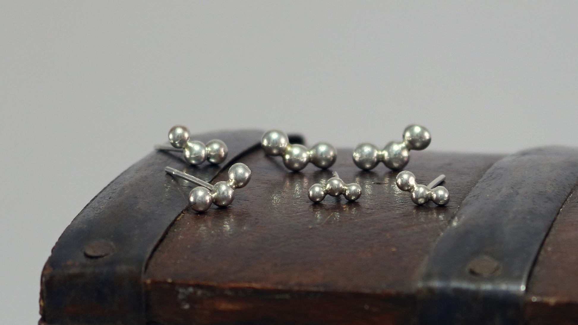 Sterling silver studs with three bubbles along a curve.