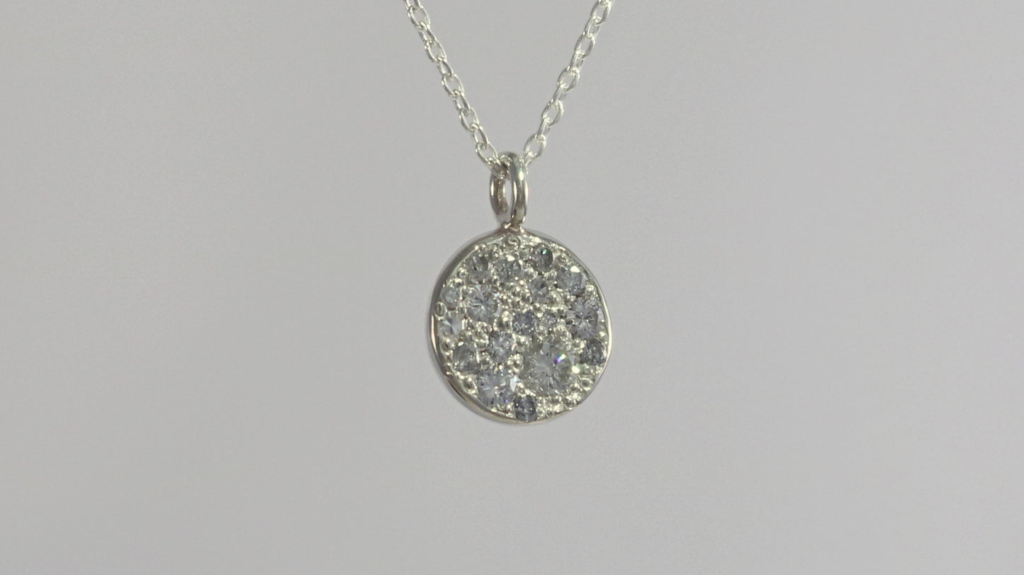 Sterling silver disc charm, pave set with diamonds on a sterling silver chain.
