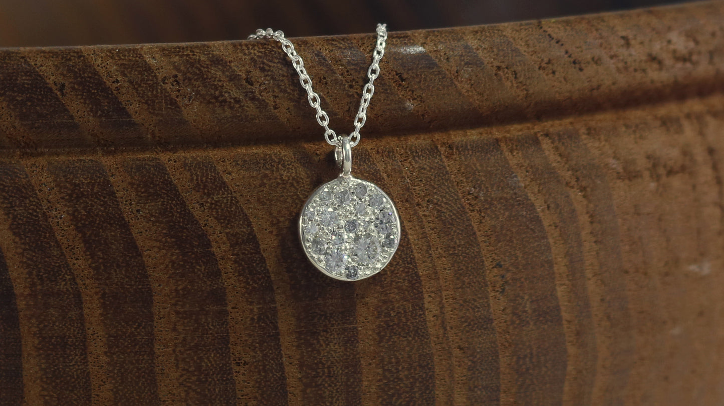 Sterling silver disc charm, pave set with diamonds on a sterling silver chain.