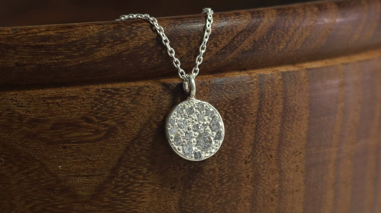 Sterling silver disc charm, pave set with diamonds on a sterling silver chain.
