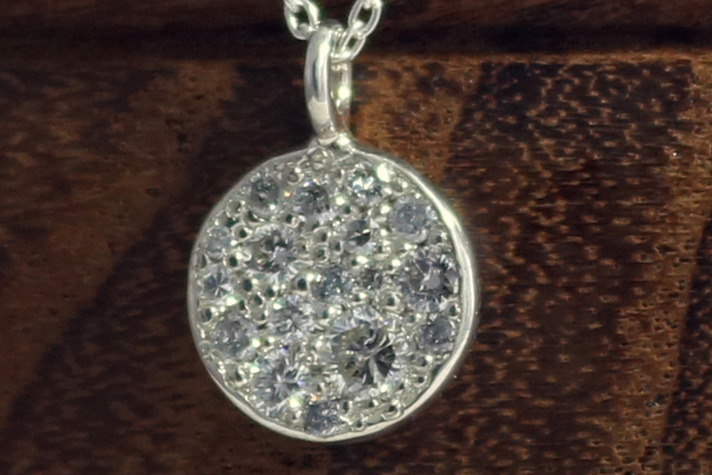 Sterling silver disc charm, pave set with diamonds on a sterling silver chain.