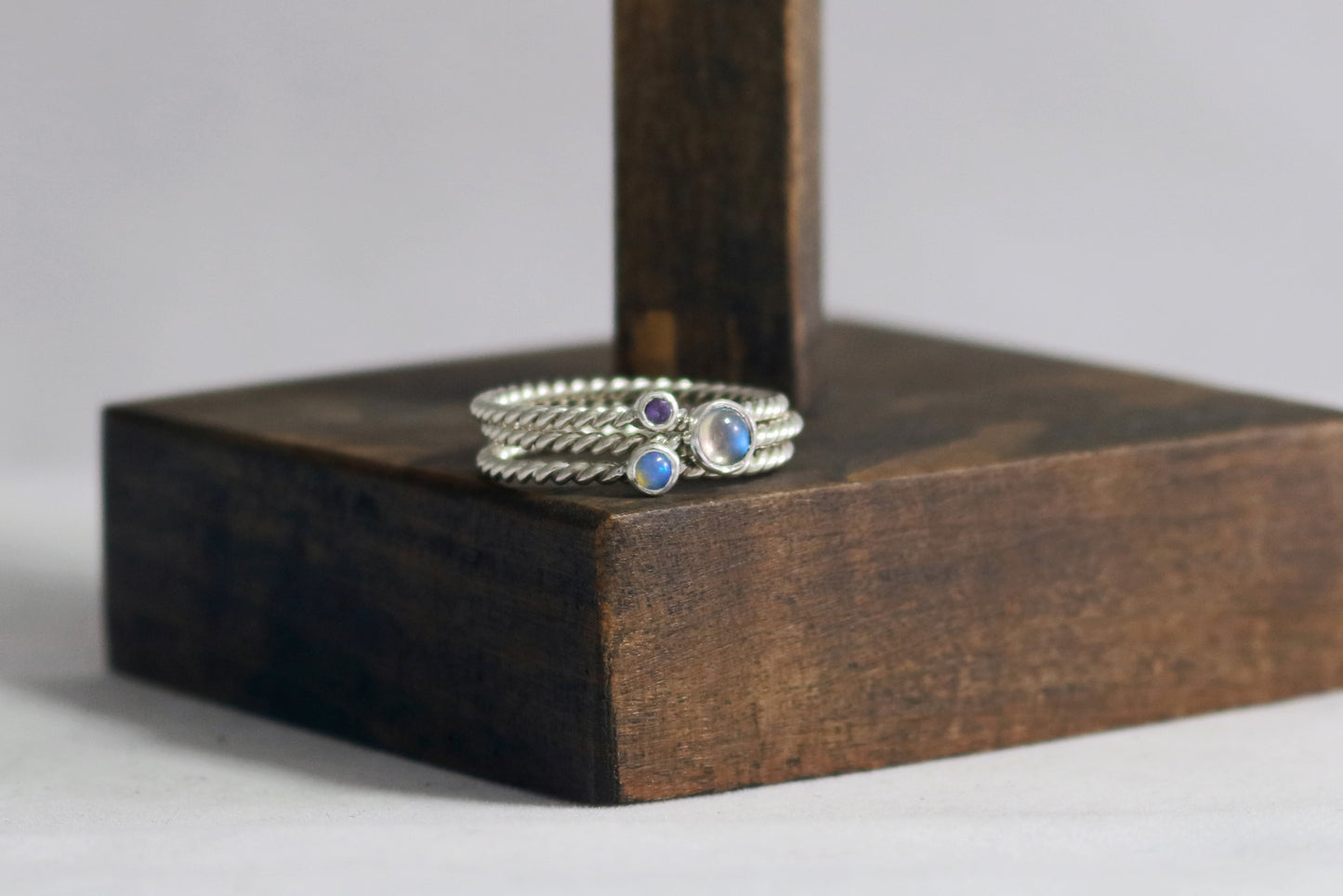 Round natural gemstone set in a sterling silver bezel on a twisted sterling silver ring band.