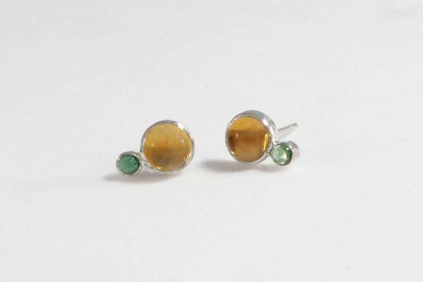 Stud earrings, natural round citrine gemstones set in sterling silver bezels with a small natural green tourmaline bezel set below.