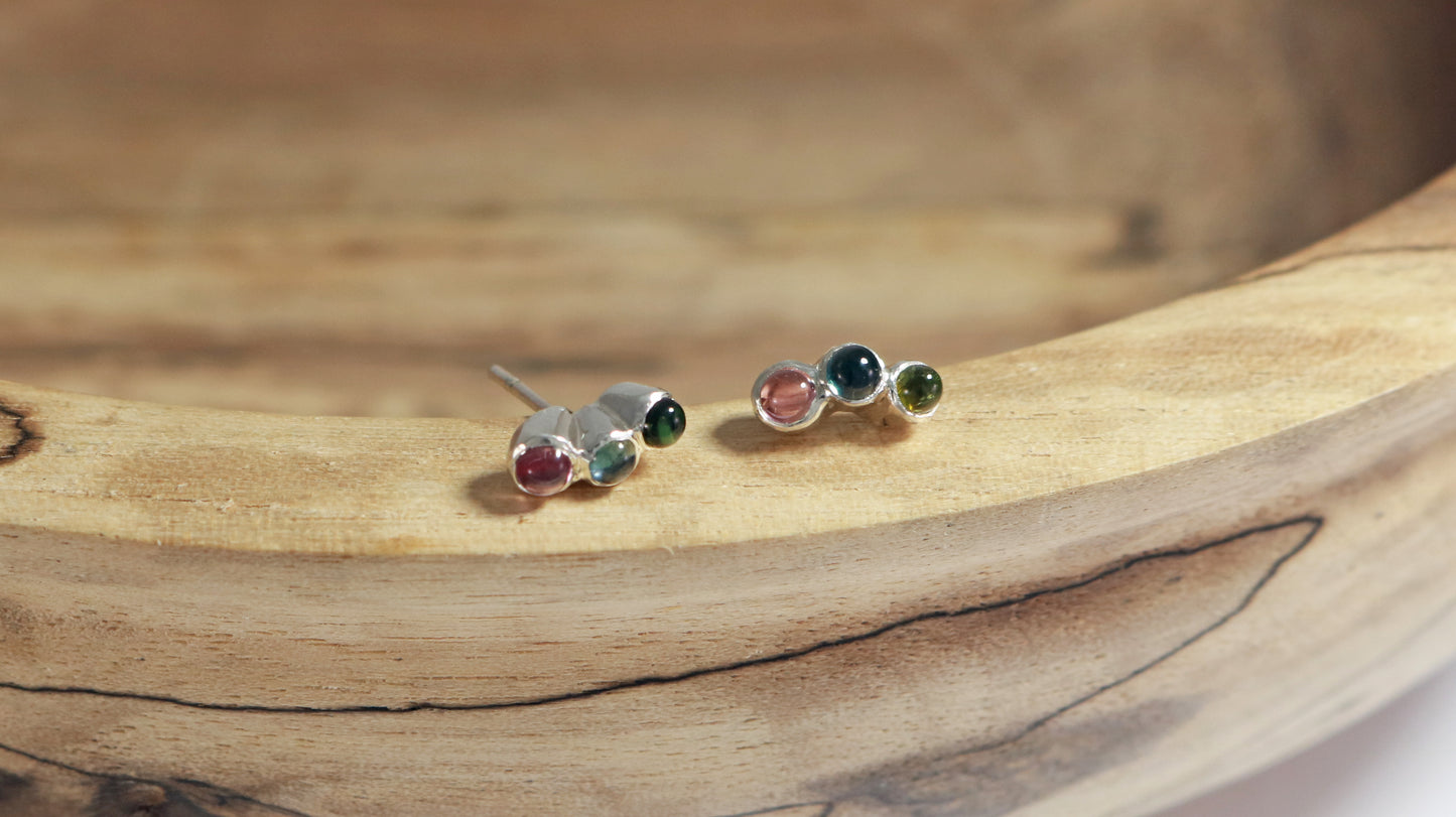 Stud earrings, 3 round natural gemstones set in sterling silver bezels on a curve.