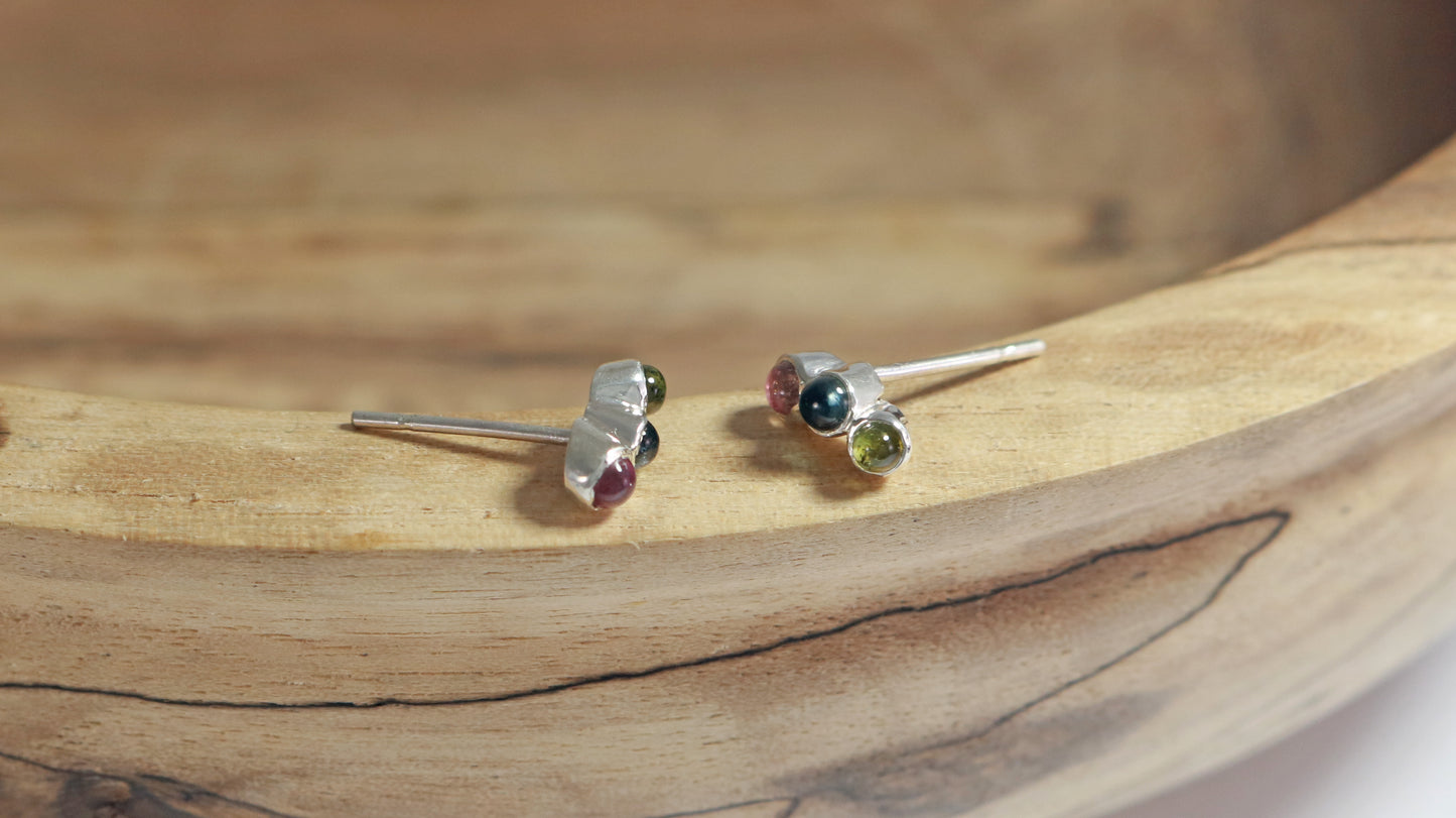 Stud earrings, 3 round natural gemstones set in sterling silver bezels on a curve.