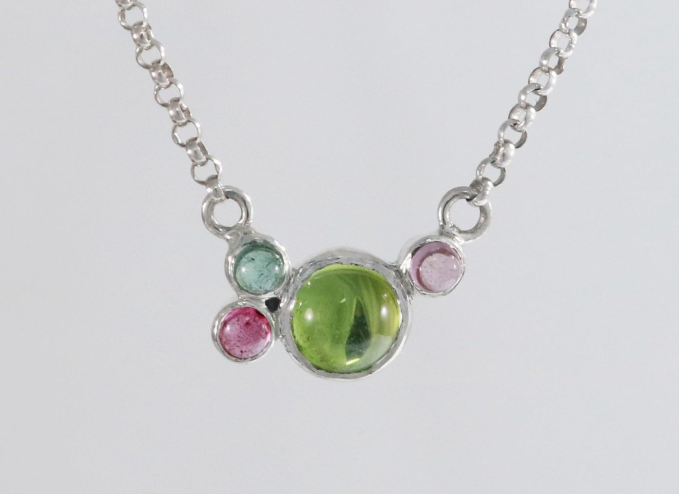 Round natural peridot & tourmaline gemstones set in sterling silver in a cluster on a sterling silver chain.