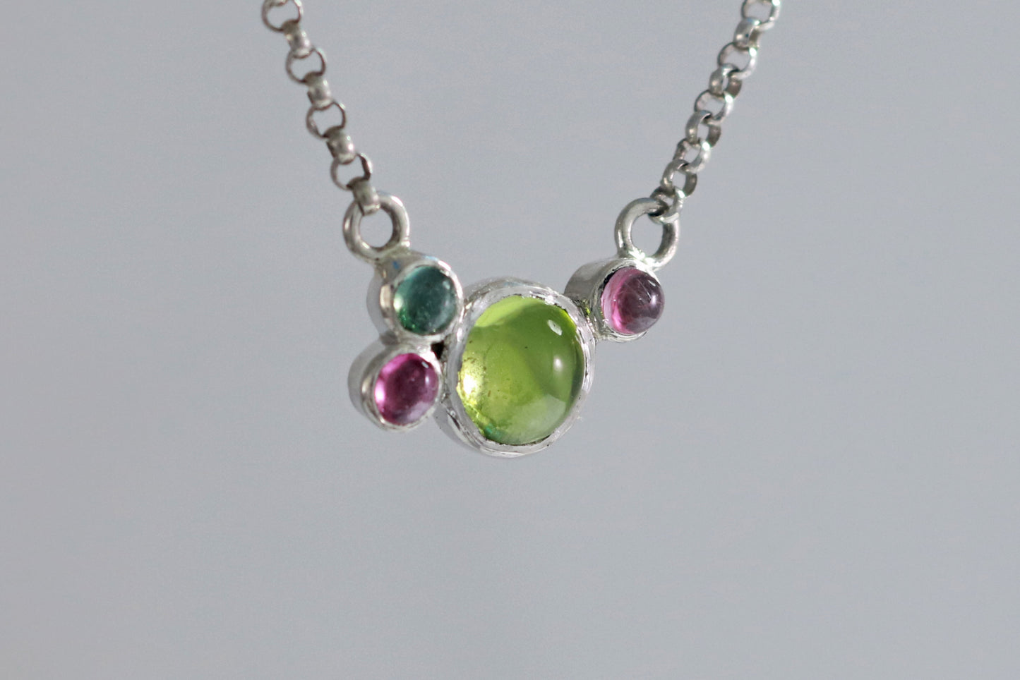 Round natural peridot & tourmaline gemstones set in sterling silver in a cluster on a sterling silver chain.
