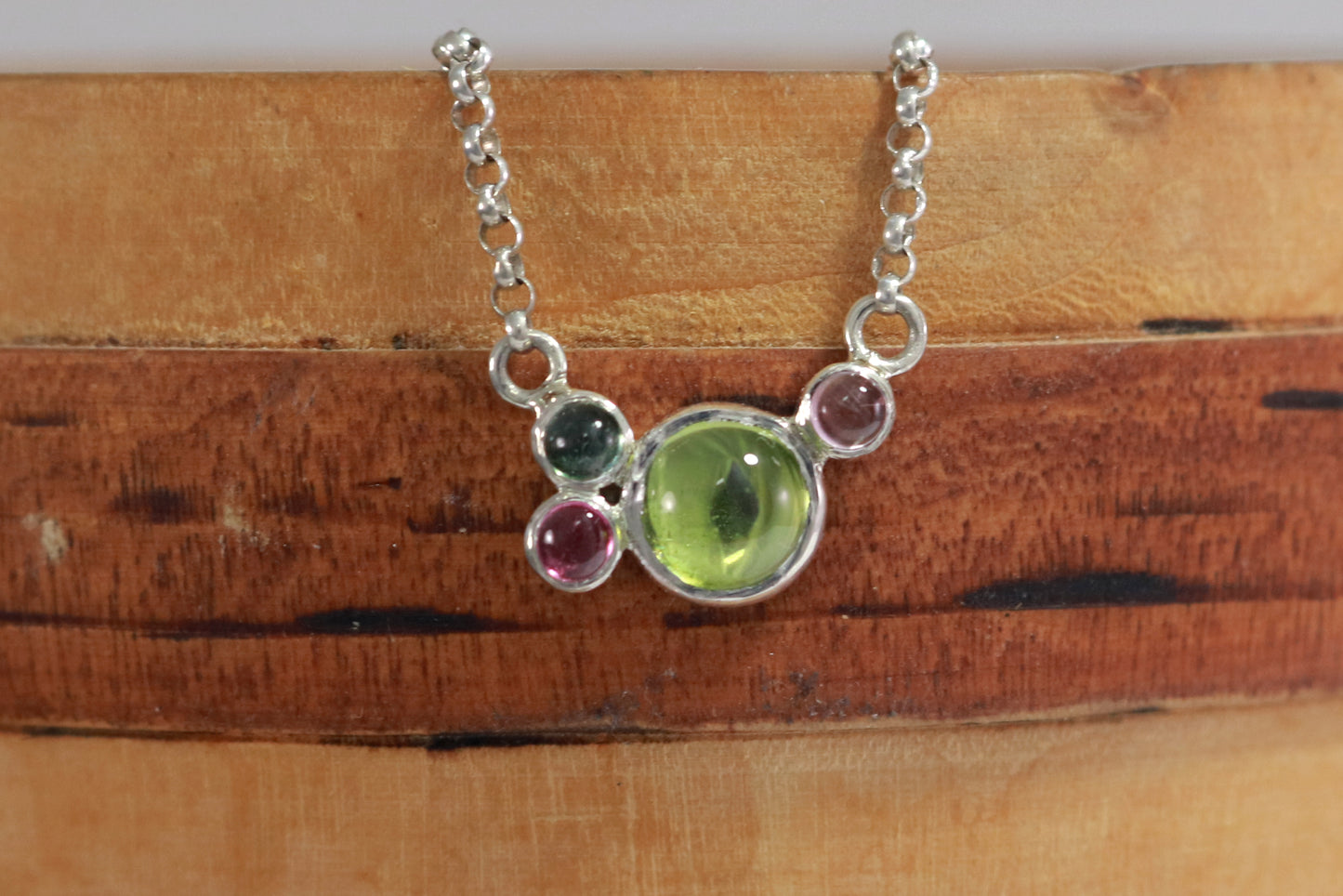 Round natural peridot & tourmaline gemstones set in sterling silver in a cluster on a sterling silver chain.