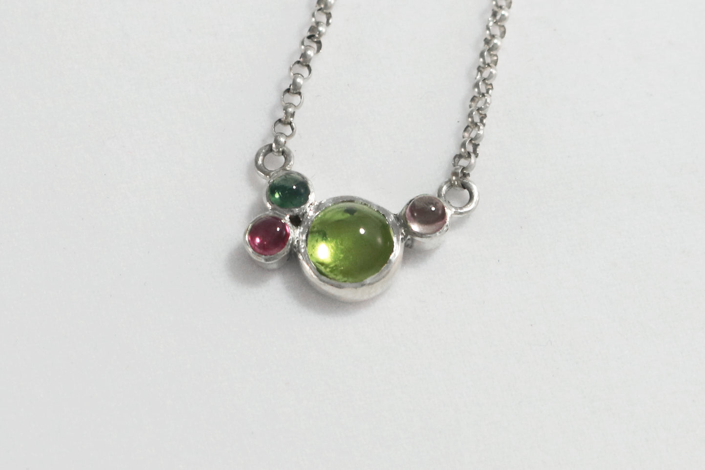 Round natural peridot & tourmaline gemstones set in sterling silver in a cluster on a sterling silver chain.