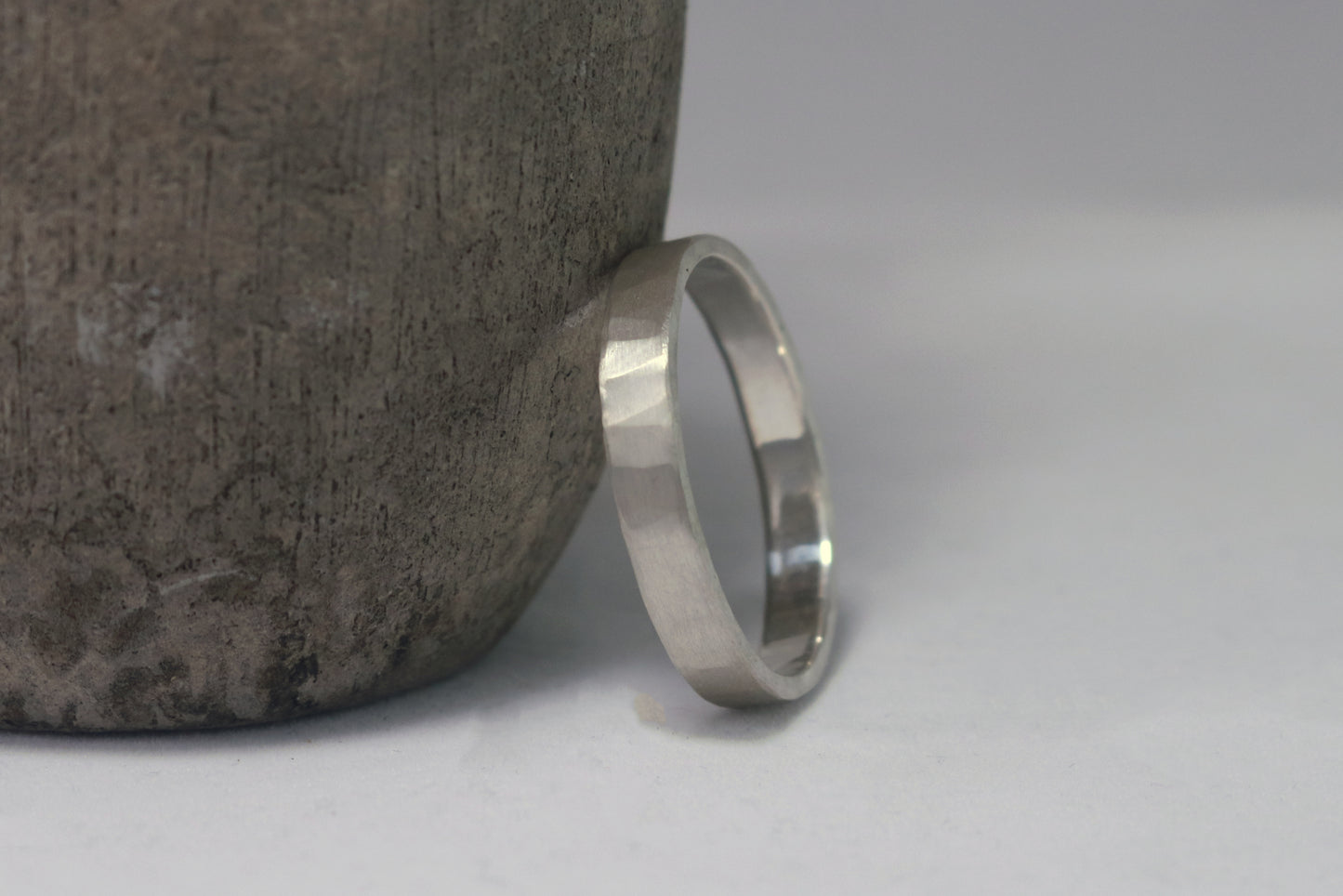 A 4mm silver ring band with a soft hammer texture.