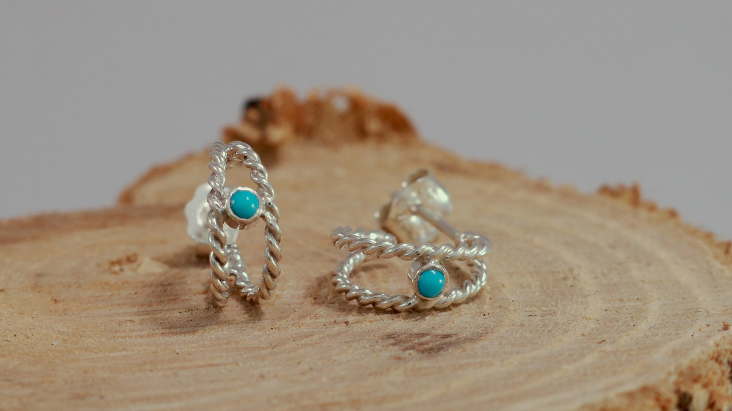 Small hoop huggie earrings made from 2 twisted sterling silver hoops with a round natural gemstone.