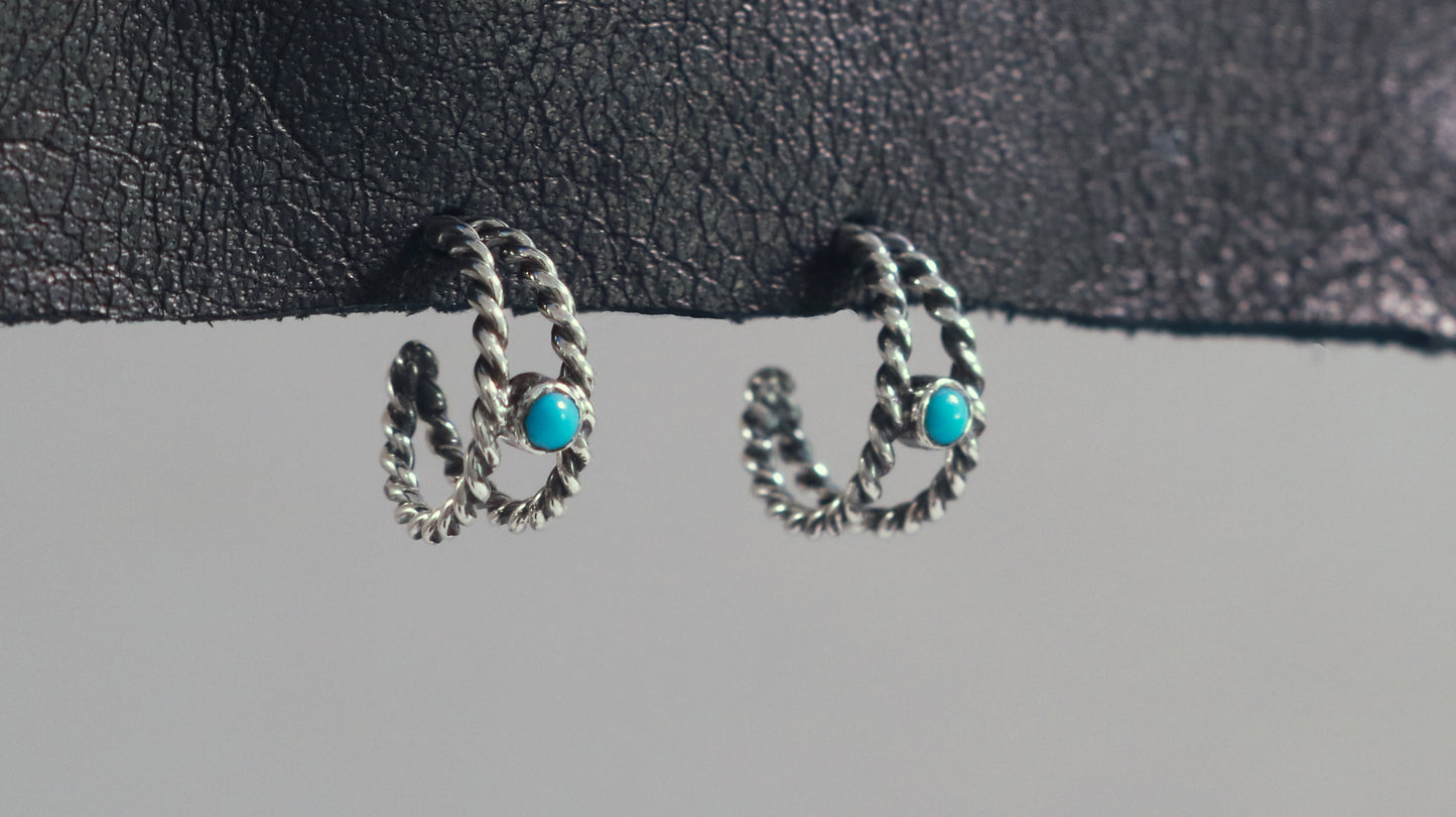 Small hoop huggie earrings made from 2 twisted sterling silver hoops with a round natural gemstone.