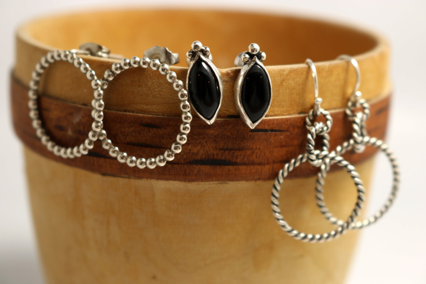 Sterling silver dangle earrings made from interlocked twisted silver circles.