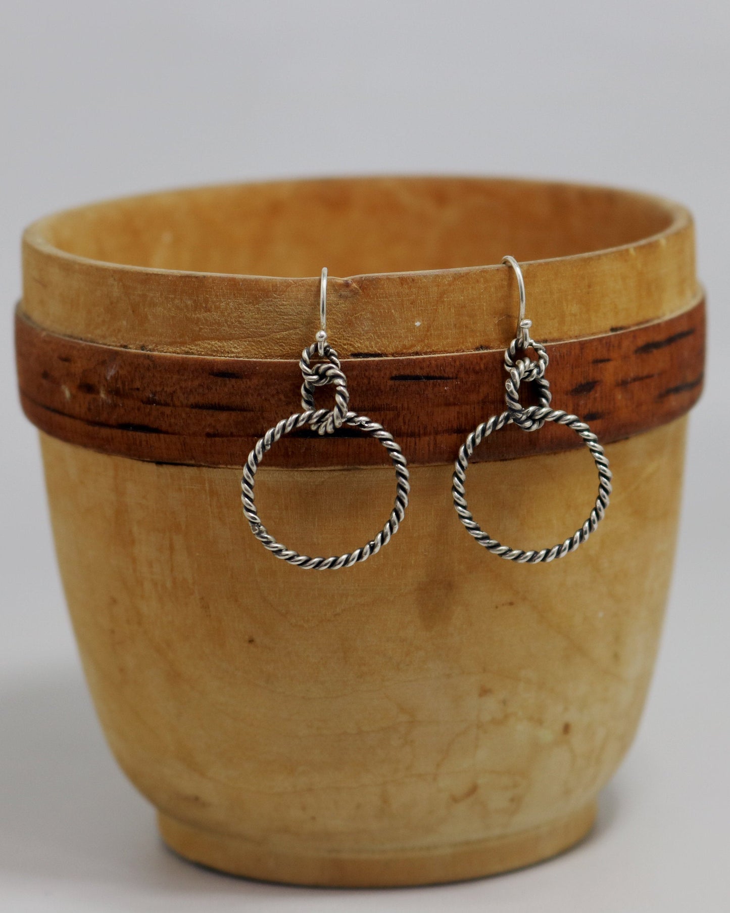 Sterling silver dangle earrings made from interlocked twisted silver circles.