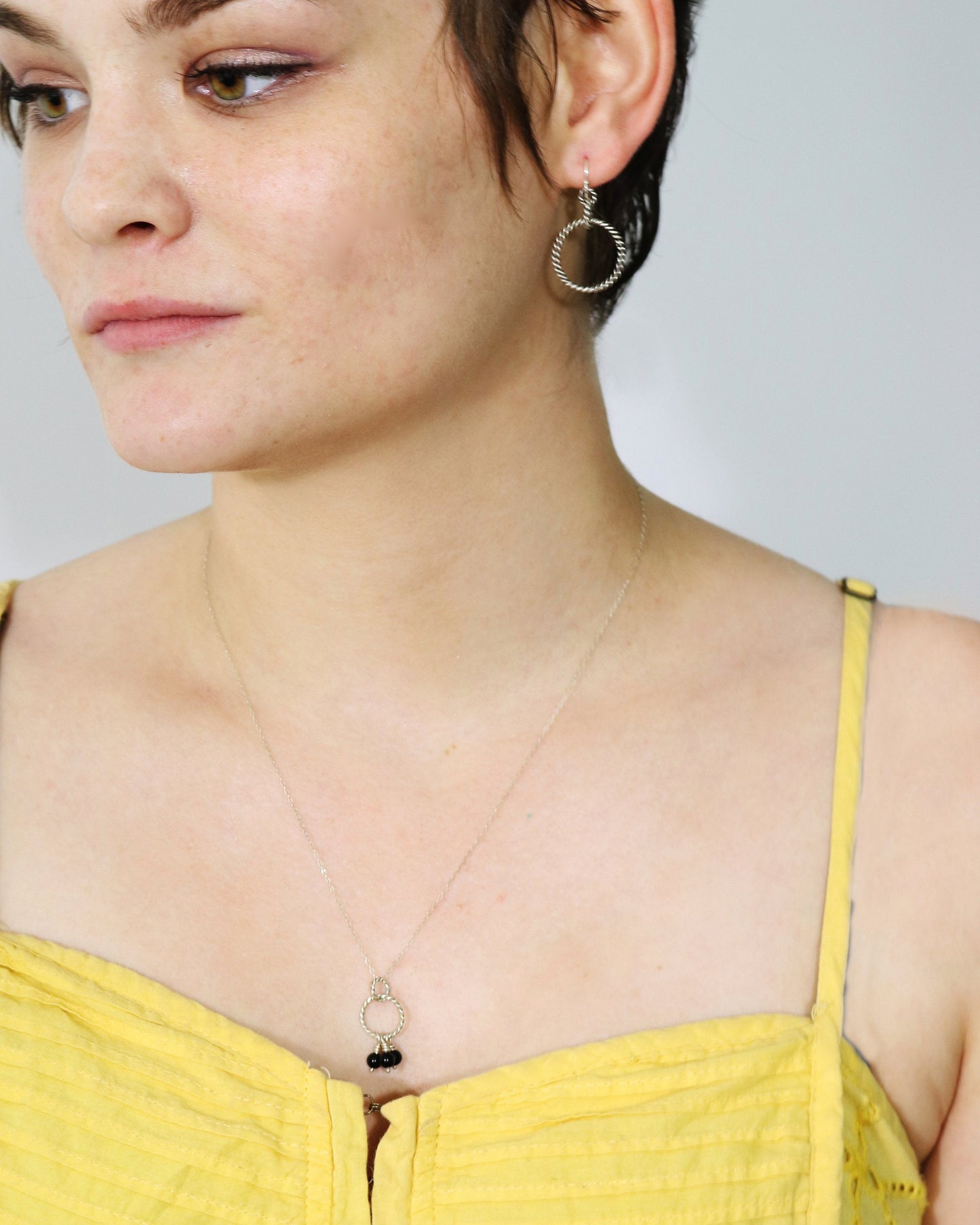 Sterling silver dangle earrings made from interlocked twisted silver circles.