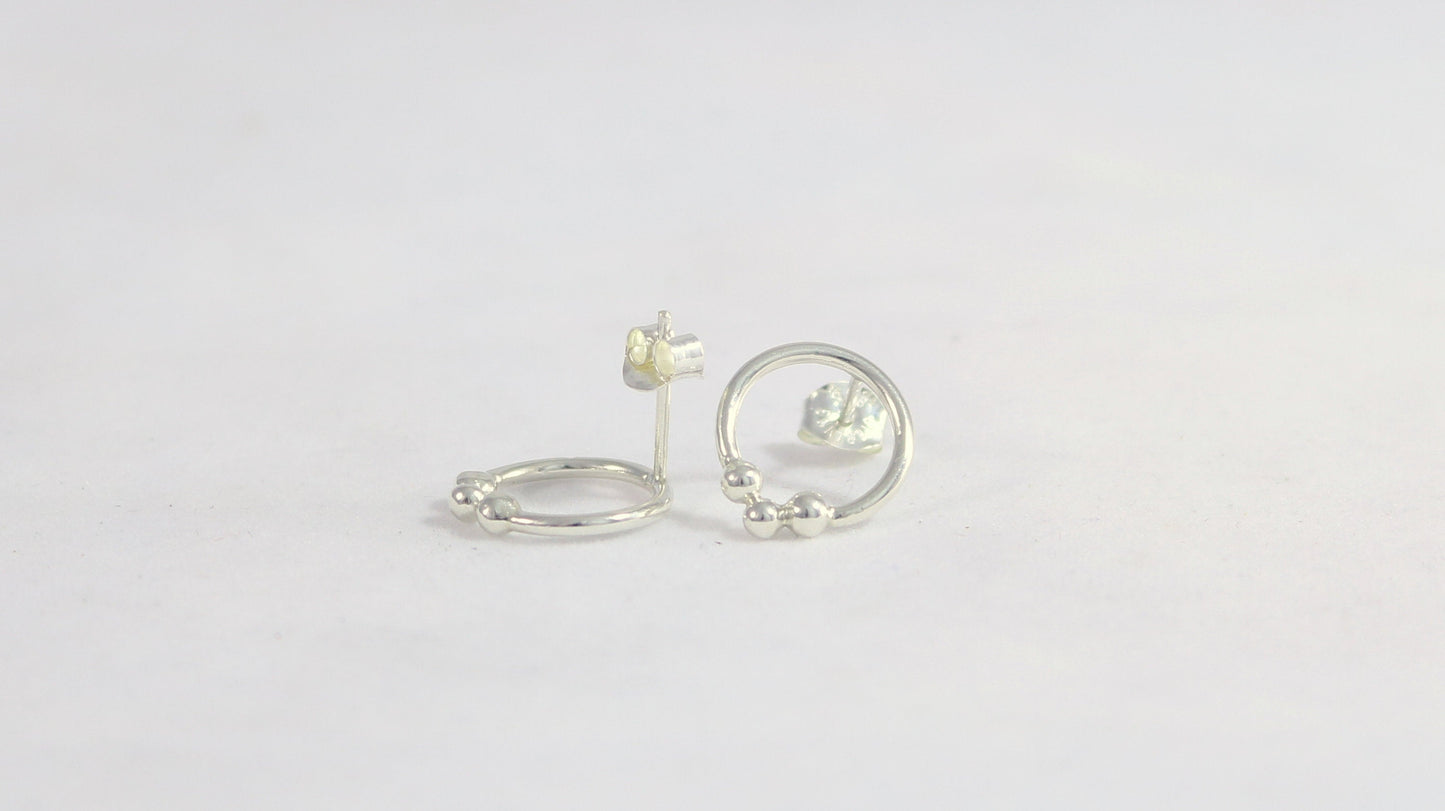 Sterling silver circle stud earrings with three silver bubbles at the bottom.