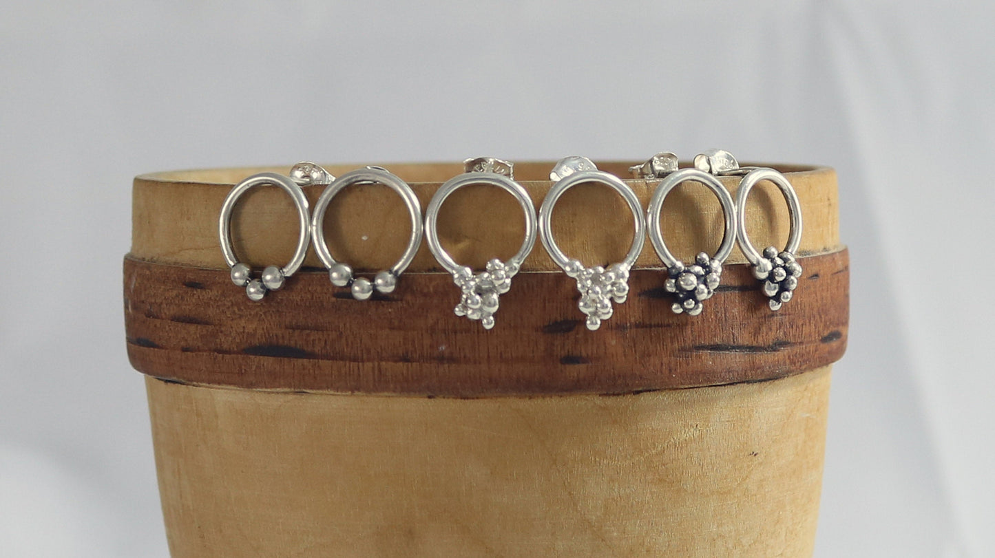 Sterling silver circle stud earrings with three silver bubbles at the bottom.