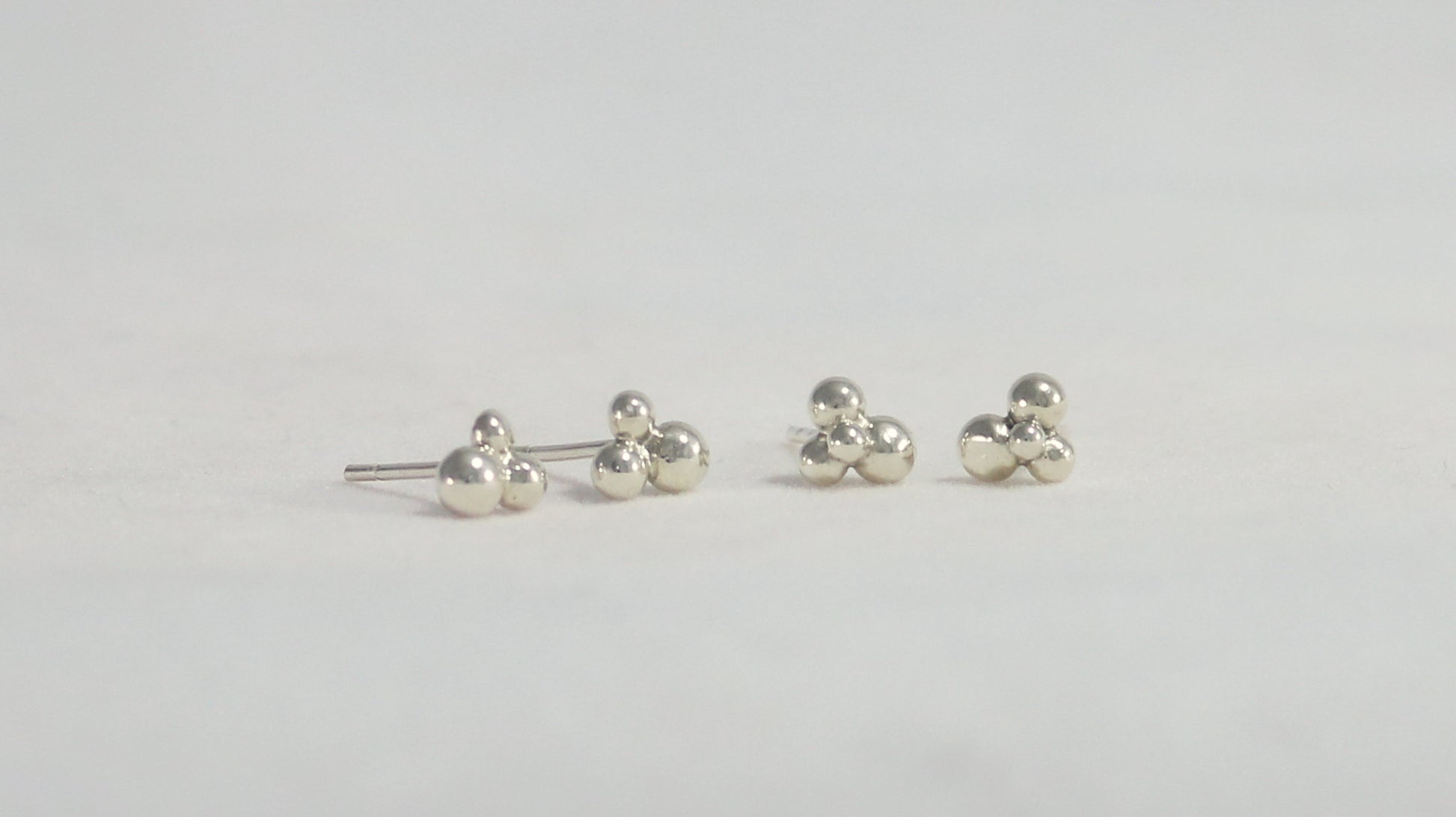 Stud earrings with three sterling silver bubbles in a pyramid.