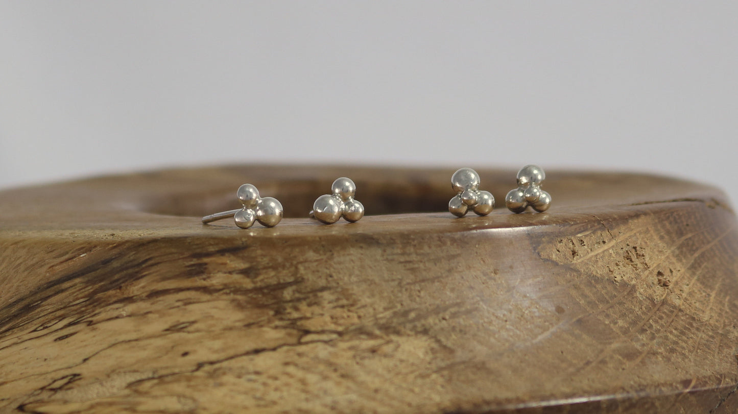 Stud earrings with three sterling silver bubbles in a pyramid.