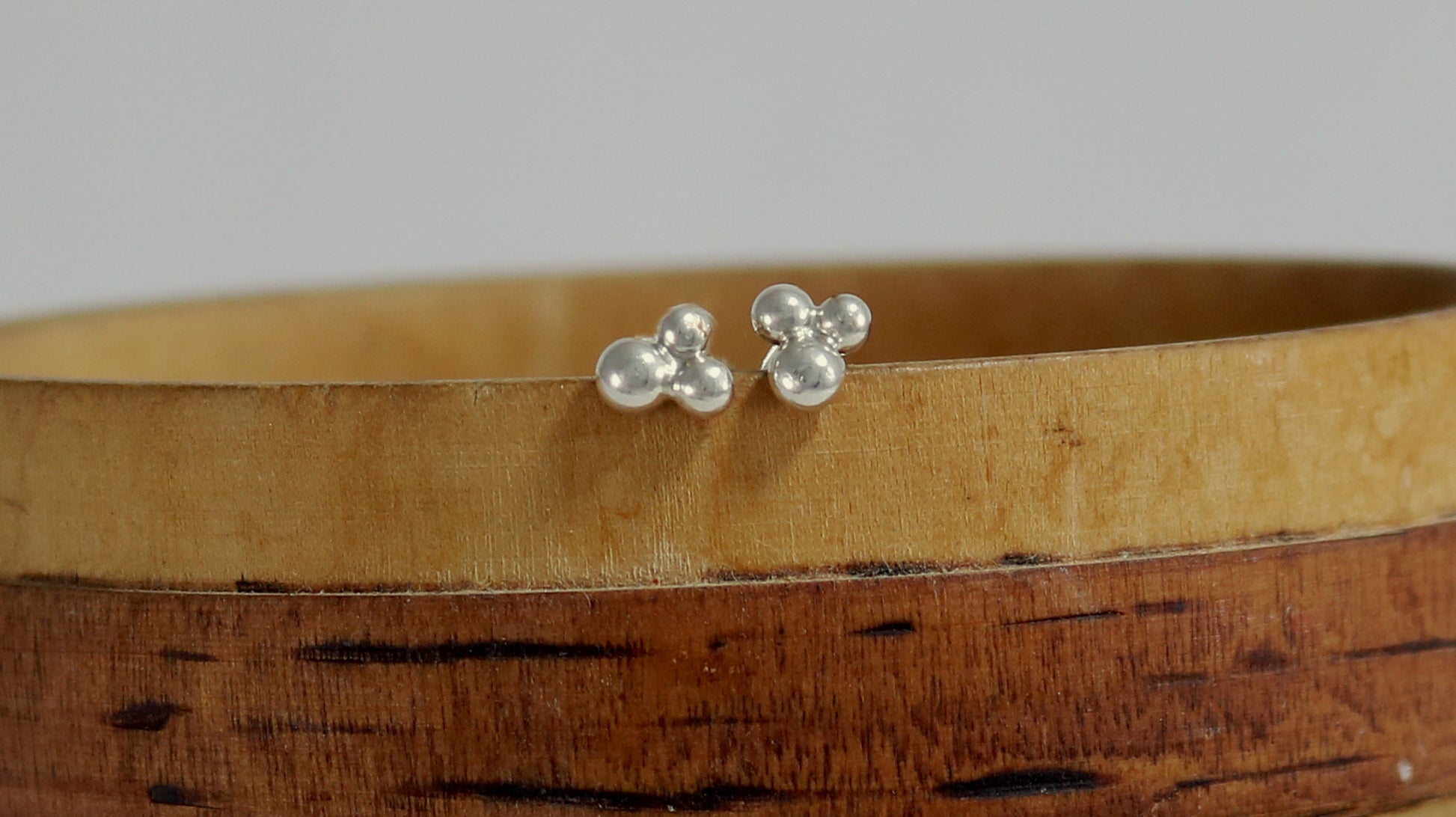 Stud earrings with three sterling silver bubbles in a pyramid.