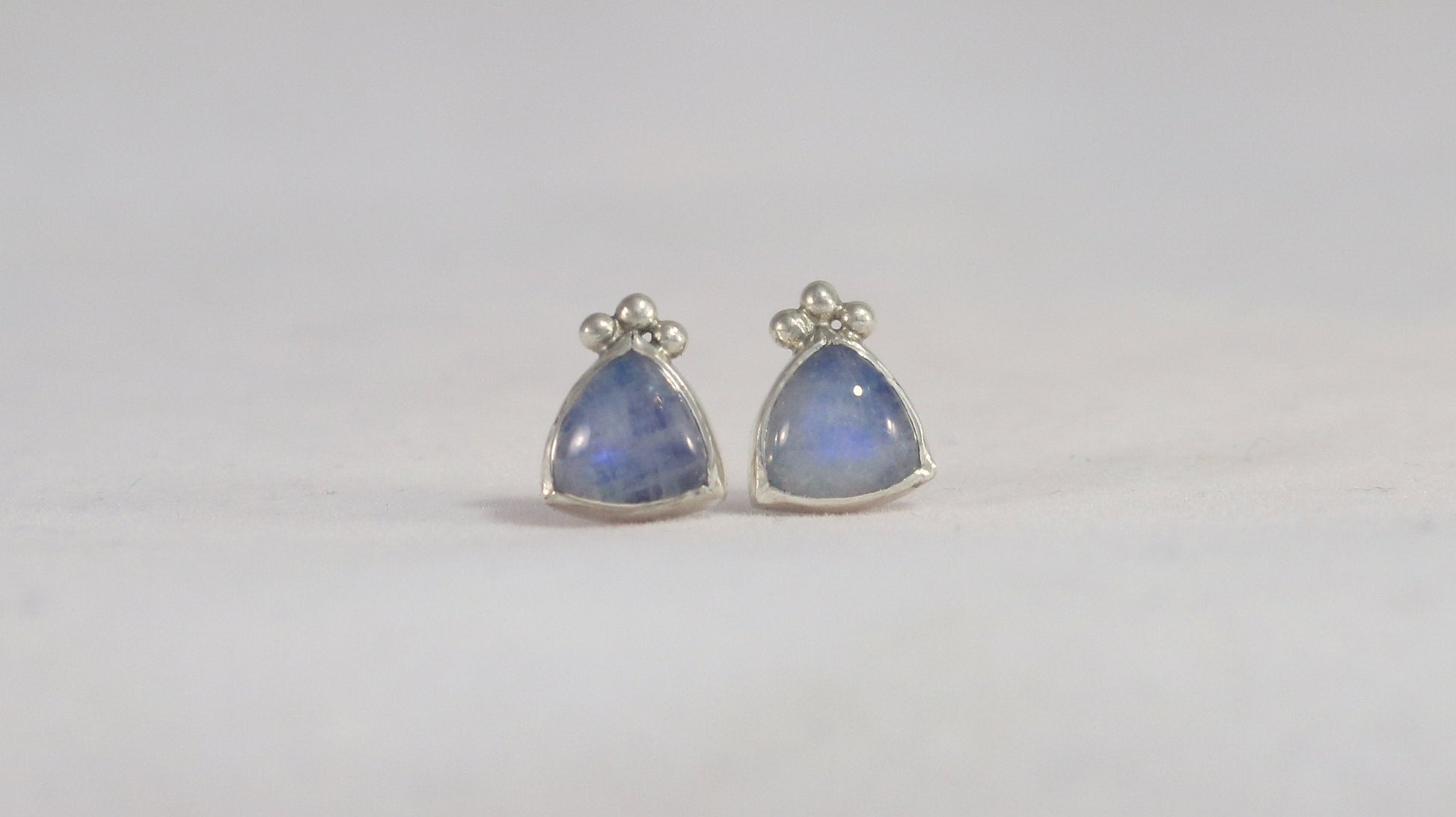 Natural trillion gemstones set in sterling silver bezel with 3 silver bubble accents, stud earrings.