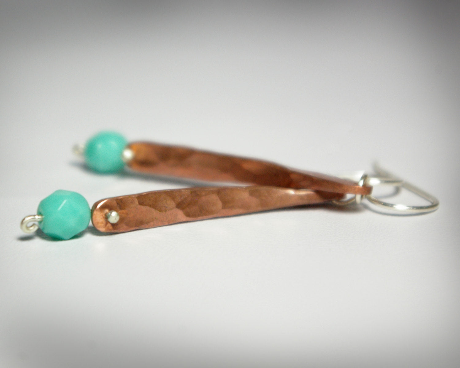Hammered copper bar dangle earrings with turquoise glass bead.