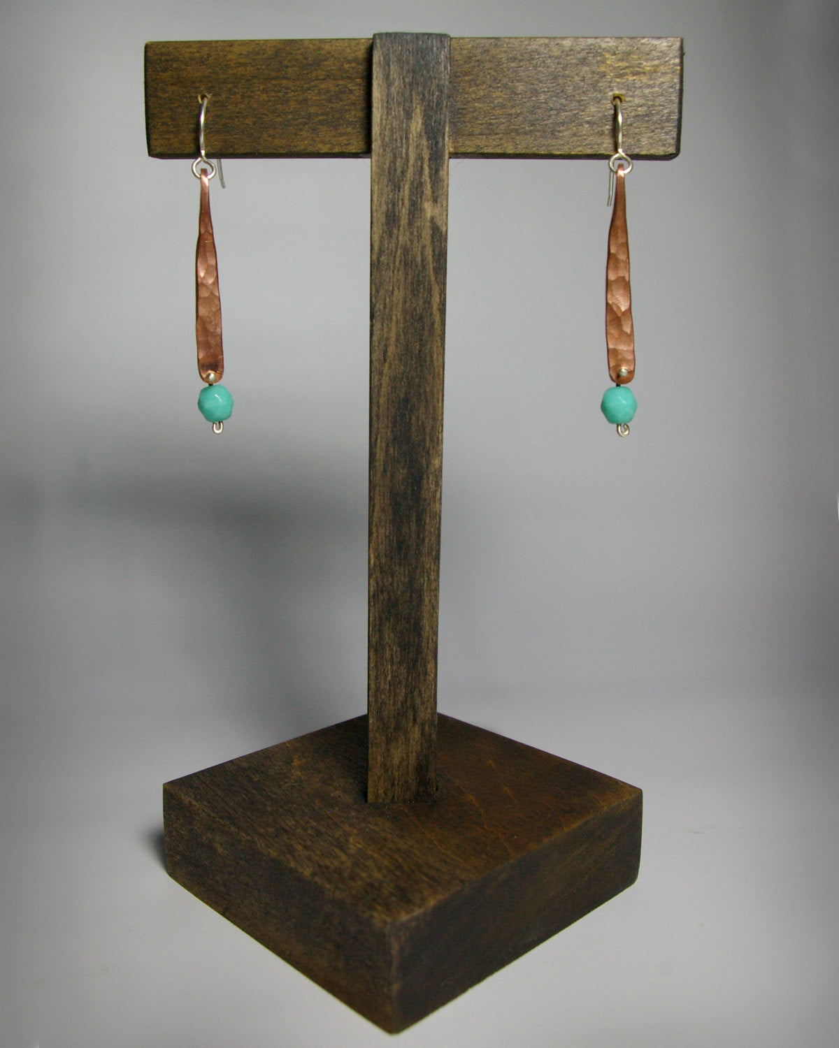 Hammered copper bar dangle earrings with turquoise glass bead.