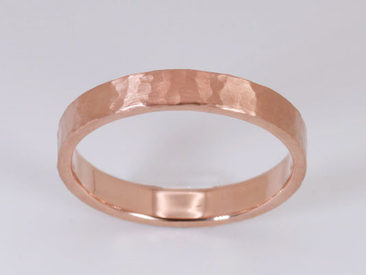 Solid 14k gold ring band measuring 4mm wide, textured with a hammer and finished with a matte surface.