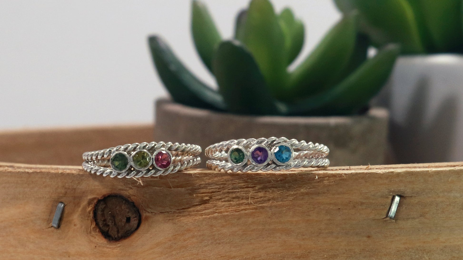 3 round natural gemstones bezel set in sterling silver between two twisted silver ring bands. 