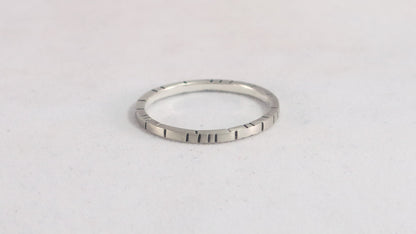 Sterling silver 1.5mm small stacking ring with randomly spaced black lines on all sides.