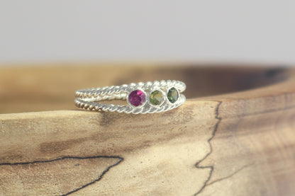 3 round natural gemstones bezel set in sterling silver between two twisted silver ring bands. 