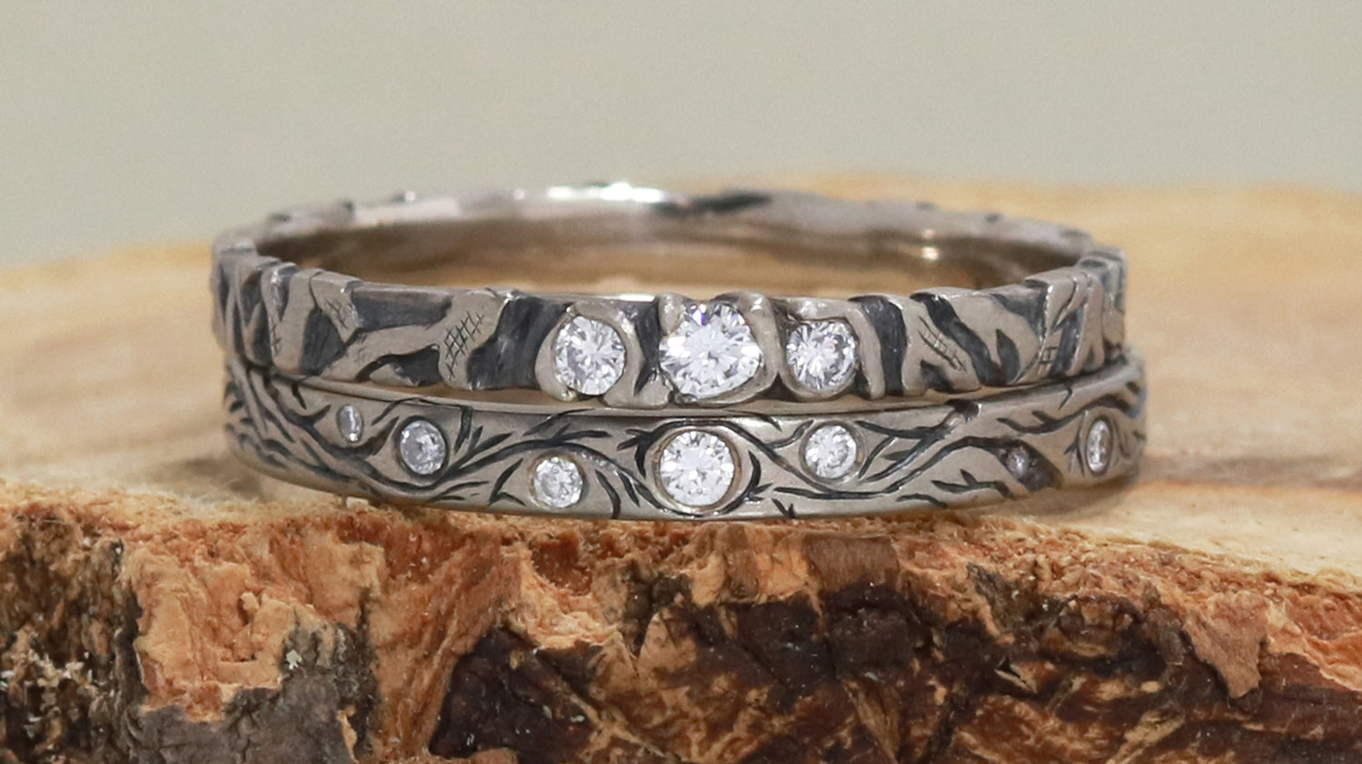 A custom wedding set made from solid 14k white gold and diamonds with hand carved vines and tree branches going around the entire ring. Inspired by nature and very organic.