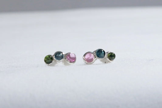 Stud earrings, 3 round natural gemstones set in sterling silver bezels on a curve.