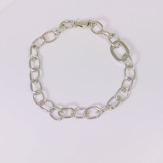 Sterling silver oval link bracelet with one thick oval link.