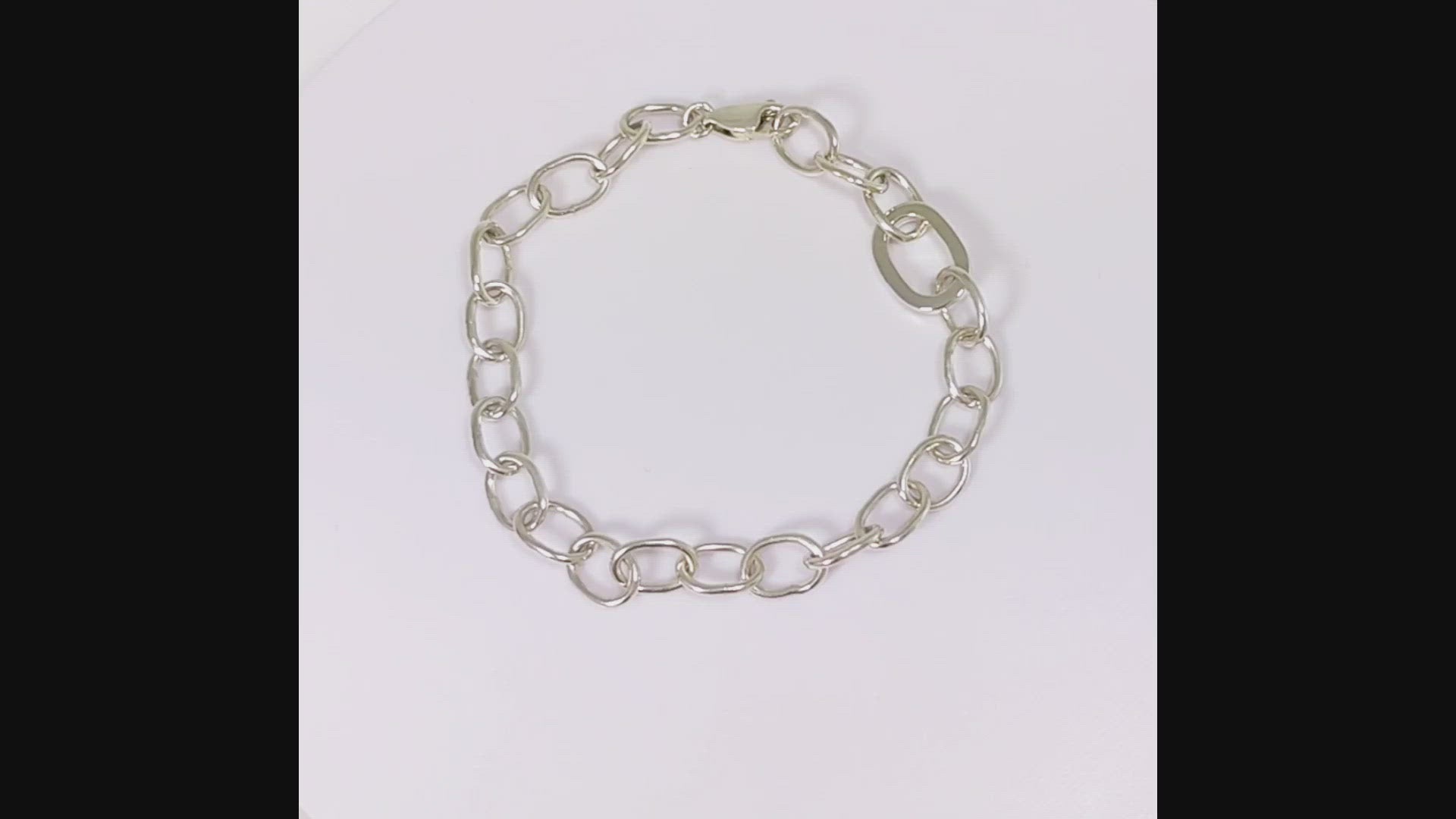 Sterling silver oval link bracelet with one thick oval link.