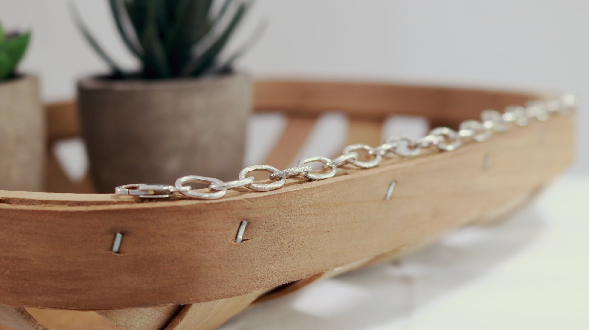 A solid sterling silver oval chain link bracelet mixed polished and textured links.