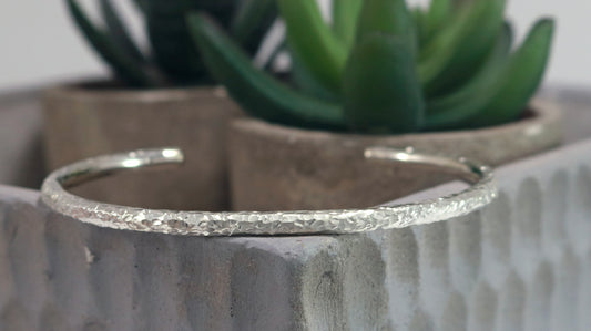 A sterling silver 4mm round hammer textured cuff.