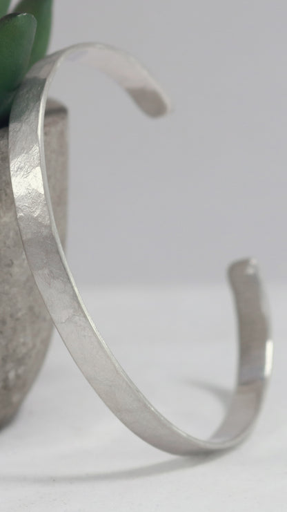 A 6mm sterling silver cuff with a weathered texture.