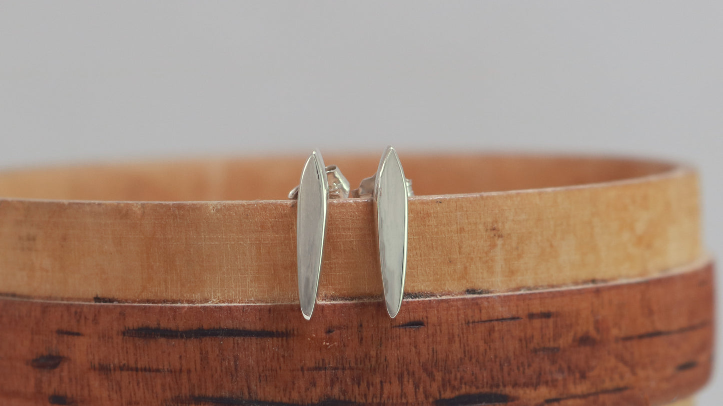 Studs made from solid sterling silver, shaped like a pointed ellipse.