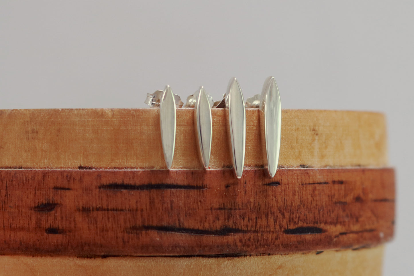 Studs made from solid sterling silver, shaped like a pointed ellipse.