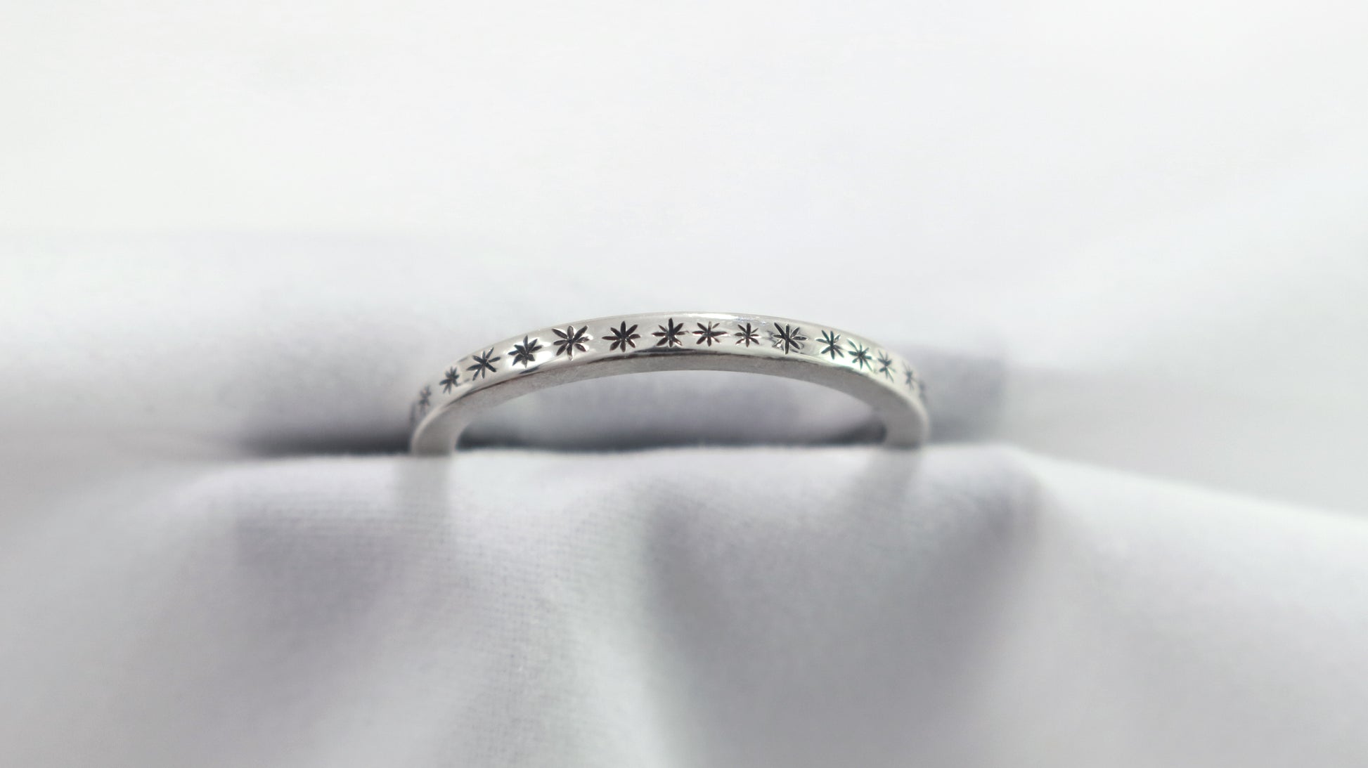 2mm squared ring band with black hand carved stars around the entire band.