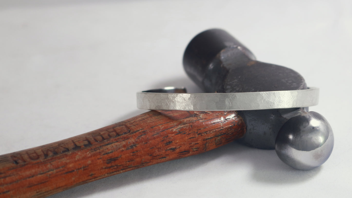 A 6mm sterling silver cuff with a weathered texture.