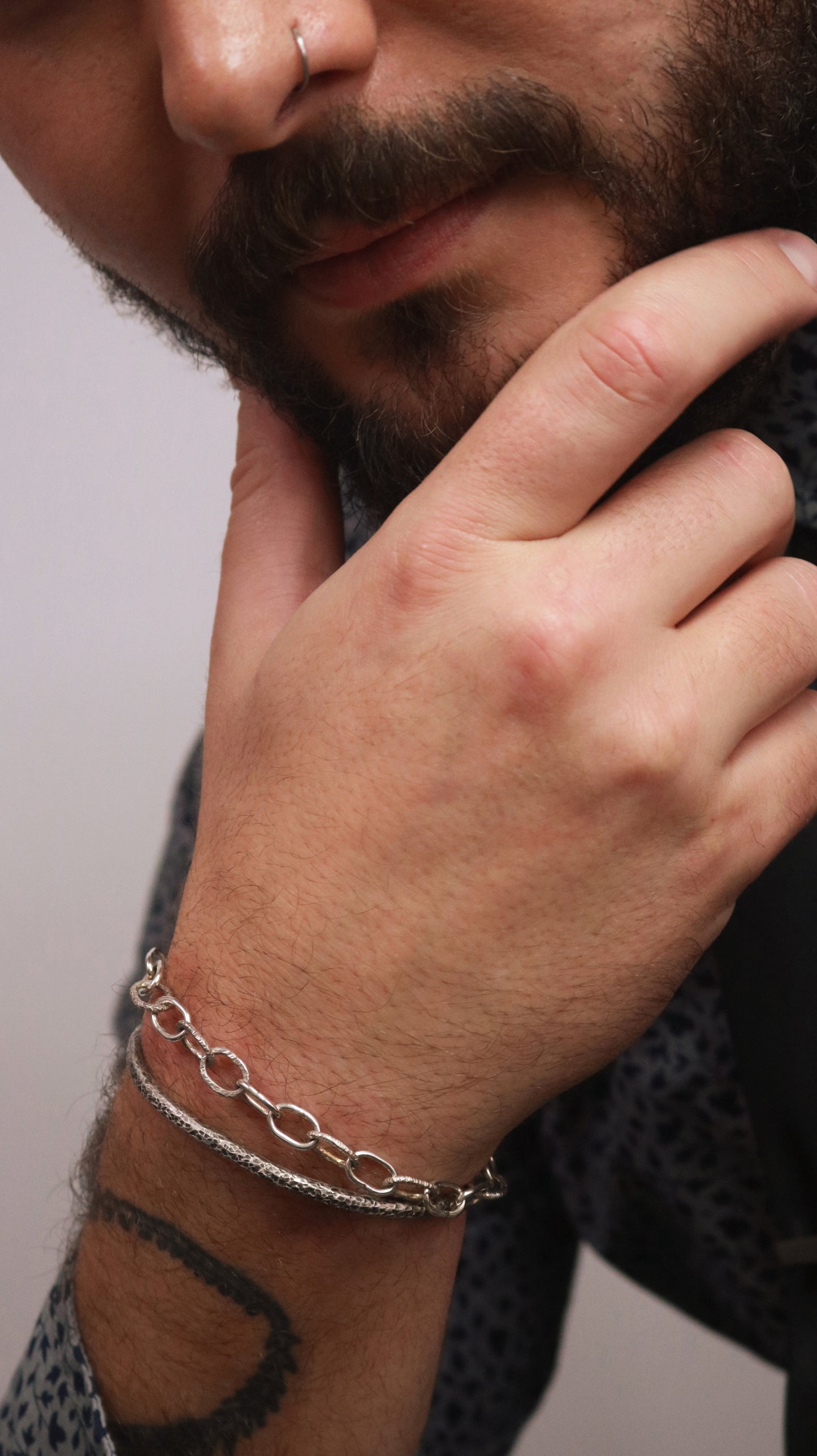 A model wearing a solid sterling silver oval chain link bracelet mixed polished and textured links.