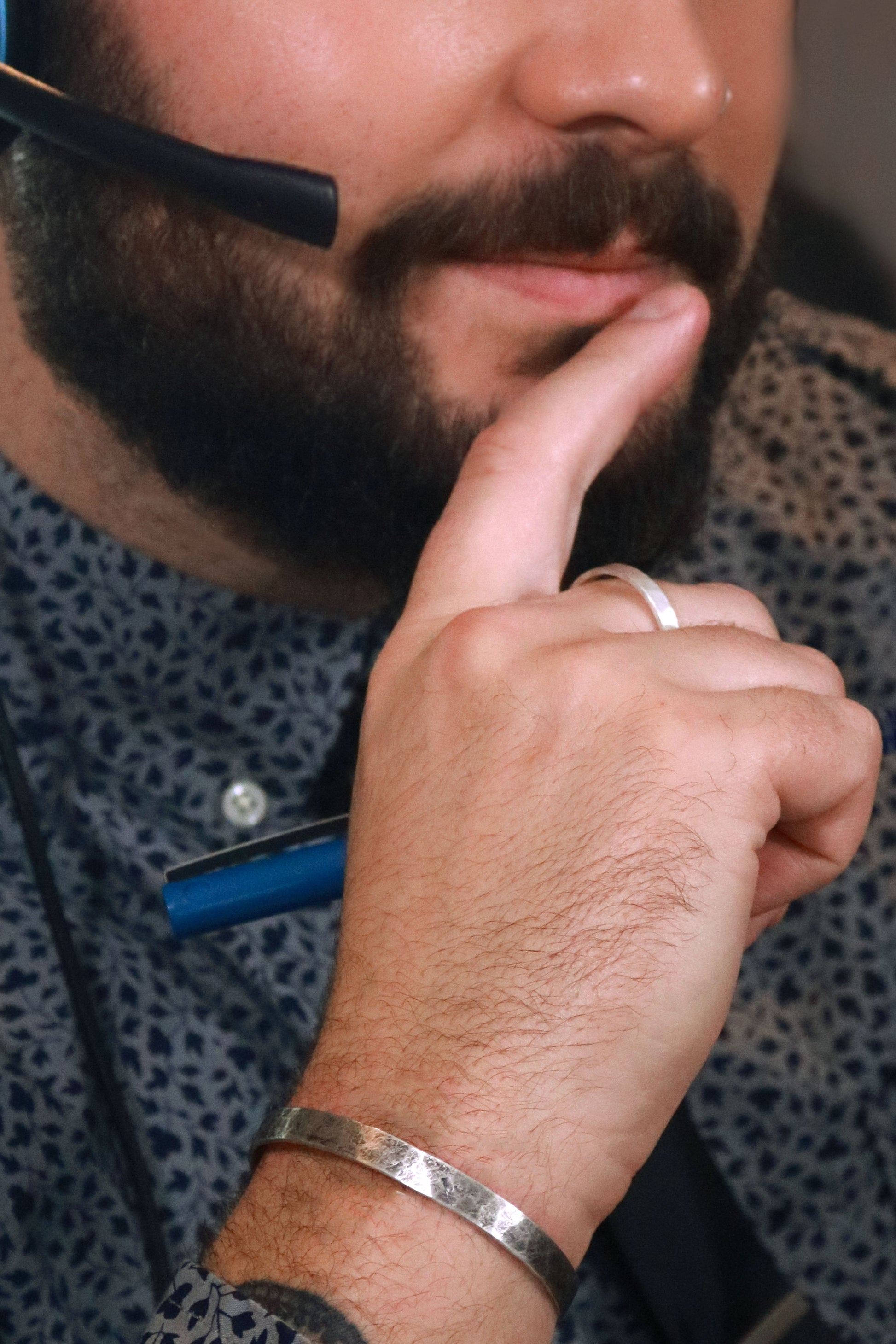 A model wearing a 6mm sterling silver cuff with a weathered texture.