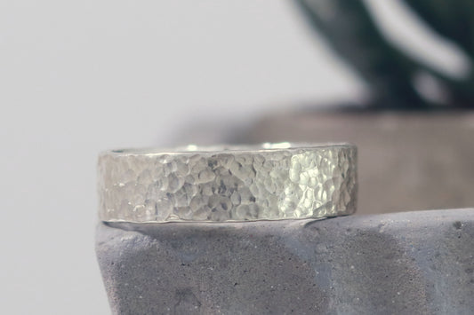 A polished solid sterling silver ring band, 6mm wide, with small dimpled hammer texture.